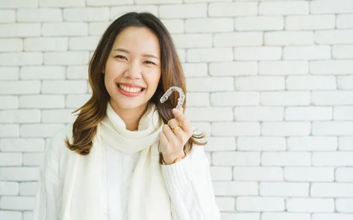 women holding aligner