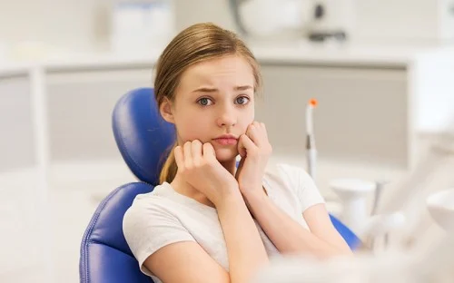 girl scared in dental chair