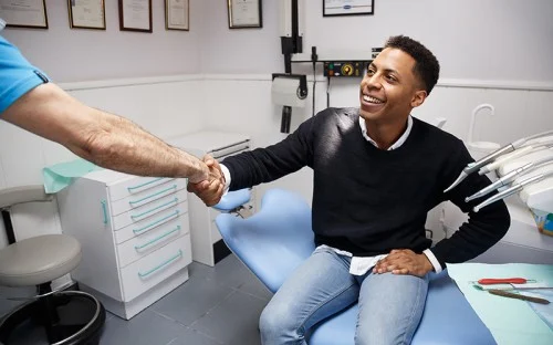 man shaking dentists hand